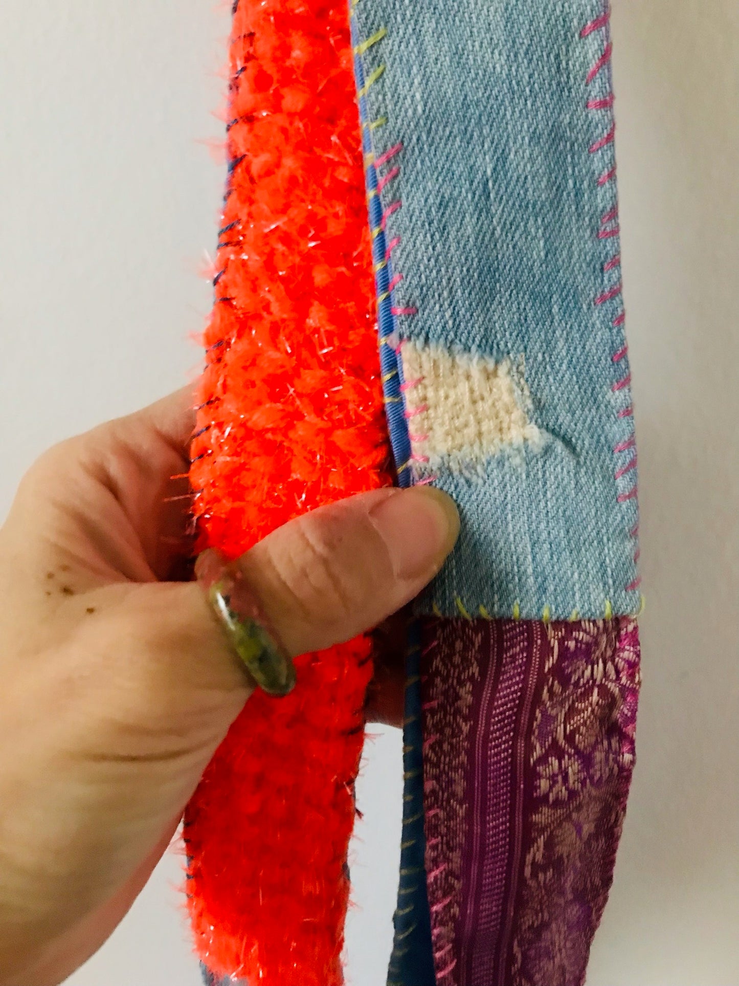 Håndstrikket rem lavet af uld, stof og garn. Et håndlavet stykke slow-fashion. Produktkode: 2122.