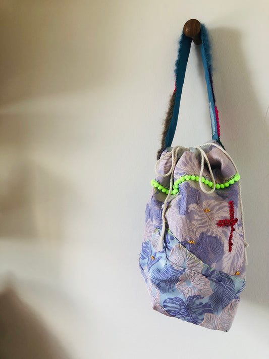 Hand-sewn fabric tote bag with drawstring and one handle, designed for slow fashion. 2250 yen.